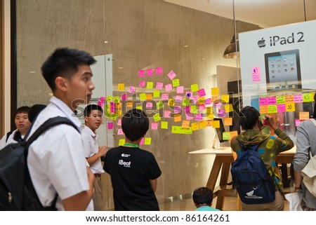 NAKHONRATCHASIMA, THAILAND - OCT 7 : Students and visitors write tributes to the late Steve Job on post-it-notes on iStudio glass wall on October 7, 2011 in Nakhonratchasima, Thailand.