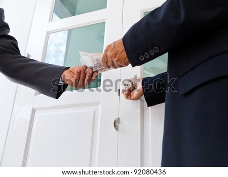 businessman renting a room with bank note in hands and pretty white door