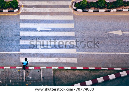 undefined woman trying to cross by zebra line on road image processed by pastel color technique