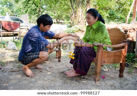 CHAIYAPHUM, THAILAND - APRIL 13: Thai people celebrate Songkran (new year / water festival: 13 April) by giving garlands to their seniors and asked for blessings on April 13, 2012 in Chaiyaphum, Thailand.