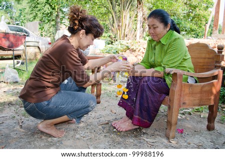CHAIYAPHUM, THAILAND - APRIL 13: Thai people celebrate Songkran (new year / water festival: 13 April) by giving garlands to their seniors and asked for blessings on April 13, 2012 in Chaiyaphum, Thailand.