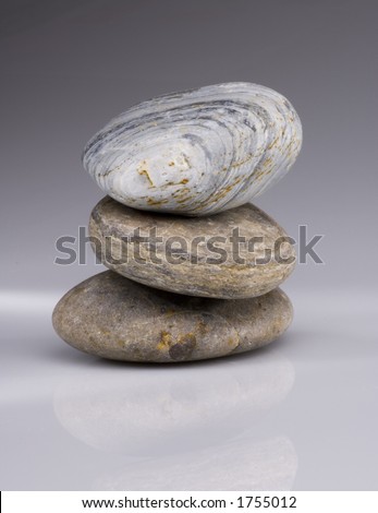 Balancing pebbles on a reflective surface