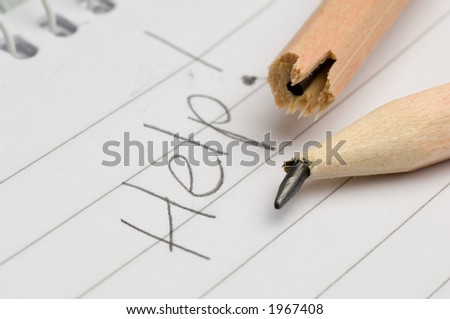 Broken pencil on a pad with the word help