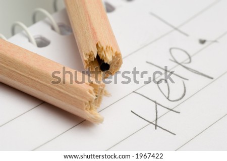 Broken pencil on a pad with the word help