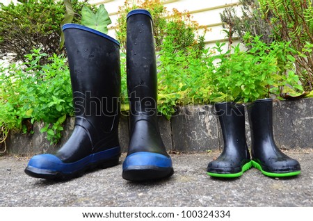 Big and small gumboots in the garden.