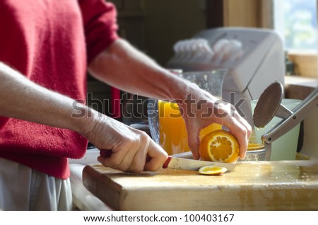 An old woman\'s hands peel citrus fruit to make fresh orange juice.Concept photo of mature woman, retire, retirement, lifestyle , health care, healthy lifestyle, healthy food, healthy drinks, fruits.