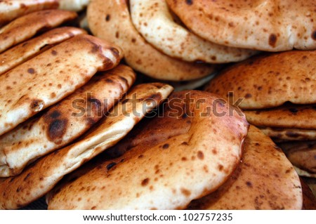 Fresh Pita breads in a bakery. food background.