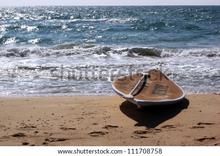 A Hasake lies on a beach. Hasake is a Middle Eastern and Israeli SUP (Stand Up Paddleboard) - surfing sports, usually used by Israeli lifeguards to save swimmers lives from drowning in the sea.