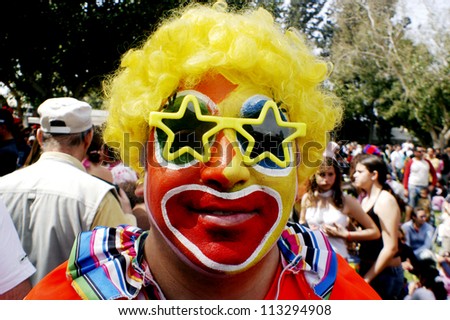 ASHKELON - MARCH 14: Israeli man dressed up with a clown costume celebrate the Jewish holiday Purim on March 14 2006 in the Ashkelon, Israel.