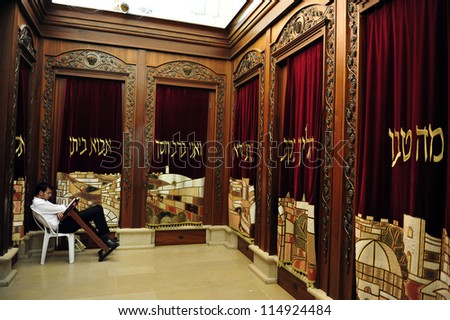 JERUSALEM - JULY 30: A Jewish man prays in a synagogue,reads a torah book (siddur) on July 30 2009 in Jerusalem,Israel.Synagogue is not viewed as replacing the long-since destroyed Temple in Jerusalem