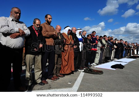 EREZ CROSSING - DECEMBER 31:Muslim Palestinian Arabs pray to Allah on December 31 2009.According to Islamic belief, Allah is the proper name of God and humble submission to His Will