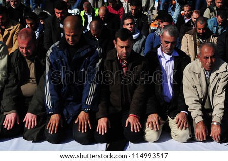 EREZ CROSSING - DECEMBER 31:Muslim Palestinian Arabs pray to Allah on December 31 2009.According to Islamic belief, Allah is the proper name of God and humble submission to His Will