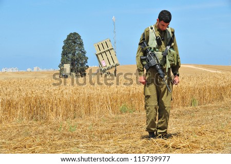 ASHKELON  - MAY 09: Iron Dome battery fighter  stands at attention to sound the siren in memory of the fallen IDF soldiers in Israel wars, on May 09 2011 in Askelon, Israel.