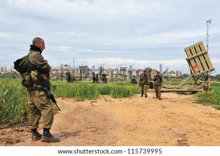 ASHKELON-APRIL 14:Israeli soldier near Iron Dome that  deployed on April 14 2011 in Ashkelon,Israel.The $200 million anti-rocket system was created by Israel against rocket attacks from the Gaza strip