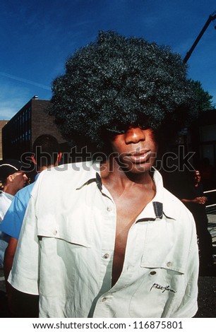LONDON -  AUGUST 16: A young black man with afro hairstyle during Notting Hill Carnival on August 16 2001 in London, UK.It\'s one of the largest street festivals in the world