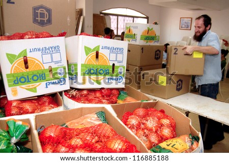 SDEROT - SEPTEMBER 05:Member of Chabad is giving food to poor Jewish families on September 05 2007 in Sderot,Israel.Chabad is an educational organization dedicated to help every Jew in the world.