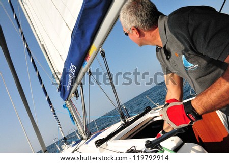 ASHDOD - SEPTEMBER 20:A skipper sails his yacht at sea on September 20 2010 in Ashdod, Israel. Yacht in Dutch  means - \