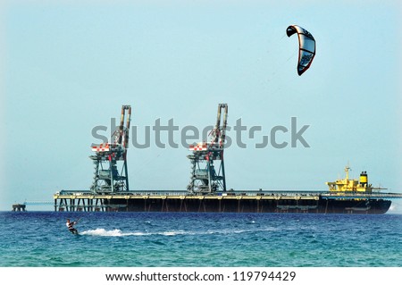 ASHKELON - JAN 29: Kitesurfer is kite boarding on January 29 2011 in Ashkelon, Israel.In 2012, the number of kitesurfers estimated to 1.5 million persons world wide.