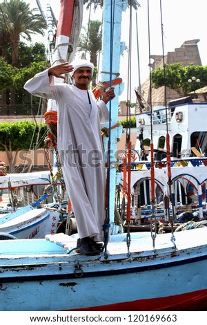 LUXOR - MAY 02:Egyptian man wearing traditional Galabia on a boat on May 02 2007 in Luxor  Egypt.It\'s oversize long sleeved shirt that covers the entire body