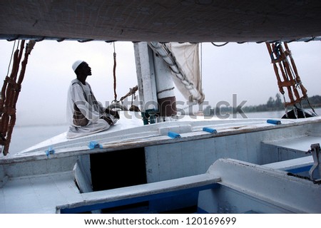 ASWAN - APRIL 28: A Muslim man pray on a Felucca Sailboat over the river Nile in Aswan, Egypt on April 28 2007.Muslim people perform praying  five times a day.