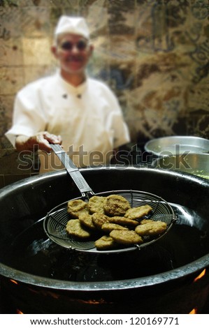 CAIRO - MAY 03 2007: Egyptian chef cooks fresh Falafel balls in restaurant in Cairo, Egypt on May 05 2007.The Copts of Egypt claim to have first made the dish as a replacement for meat during Lent.