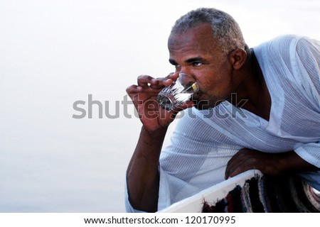 ASWAN - APRIL 28:Egyptian man drink waters from the nail river in Aswan, Egypt on April 28 2007.The Nile river provides nearly all of Egypt's fresh water.