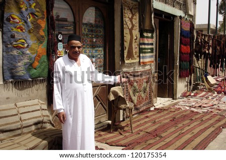 CAIRO - APRIL 27: An Egyptian rug seller sales handmade carpets in Giza City in Cairo Egypt.Egypt rug-weaving tradition that dates back to the sixteenth century.