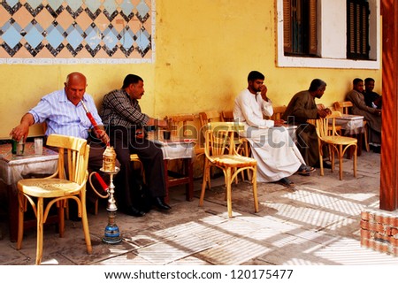 ASWAN - APRIL 28:Egyptian men smokes form Shisha pipe in a Nargila Shop on April 28 2007 in Aswan, Egypt.In the middle east and Arab world, pipe smoking is part of their culture and traditions.