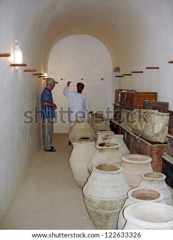 RUSTAQ -DEC 23: Omani tour guide show artefacts at Al Hazm Fort on December 23 2007 near Rustaq, Oman.It\'s an outstanding example of Omani Islamic architecture and was built in 1711 AD.