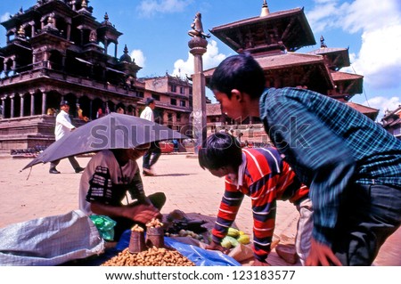 PATAN -  OCT 15:Nepali people buy nuts in Durban Square on October 15 2004 in Patan, Nepal.It\'s best known for its rich cultural heritage, particularly its tradition of arts and crafts
