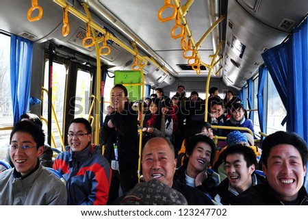 BEIJING - MARCH 10:Happy  Chinese people in a bus on the way to the Great Wall of China on MARCH 10 2008 near Beijing ,China.Four million people visits the great wall each year.