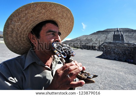 TEOTIHUCAN - FEB 26 2010: Mexican man play Mexican music under the Sun Pyramid in Teotihuacan, Mexico.It\'s the third largest pyramid in the world (738 feet/225m across and 246 feet/75m high)