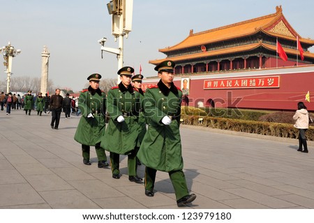 BEIJING - MARCH 11:Chinese soldiers march in Tiananmen square on March 11 2009 in Beijing,China.It\'s the third largest square in the world and important site in Chinese history