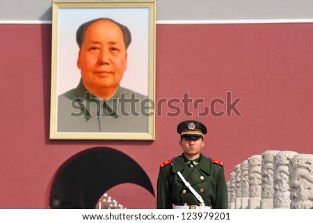 BEIJING - MARCH 11:Chinese soldier stands guard in front of a portrait of Mao Zedong in Tiananmen square on March 11 2009 in Beijing,China. Chairman Mao Zedong is still being worshiped all over China.