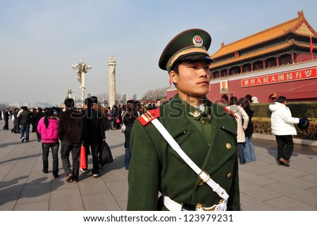 BEIJING - MARCH 11:Chinese soldier guards Tiananmen square on March 11 2009 in Beijing,China.It\'s the third largest square in the world and important site in Chinese history