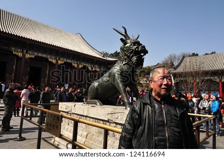 BEIJING - MAR 14:Visitors near a Chinese dragon at the Summer Palace.t The Summer Palace in Beijing China on March 14 2009.The Summer Palace is the best preserved imperial garden in the world.