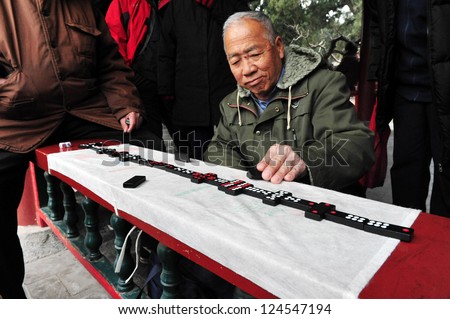BEIJING-MARCH 15:Chinese people play domino at the Temple of Heaven park on Mar 15 2009 in Beijing, China.It\'s the most popular park in Beijing used by thousands of people for sport and leisure daily