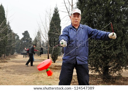 BEIJING-MARCH 15:Chinese man plays with Yo-yo at the temple of heaven park on Mar 15 2009 in Beijing,China.It\'s the most popular park in Beijing used by thousands of people for sport and leisure daily