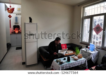 BEIJING - MARCH 12:Chinese man in his renovated apartment in a Hutong (old neighborhood) on March 12 2009 in Beijing, China.There is around 4,000 Hutongs in Beijing some are hundreds of years old