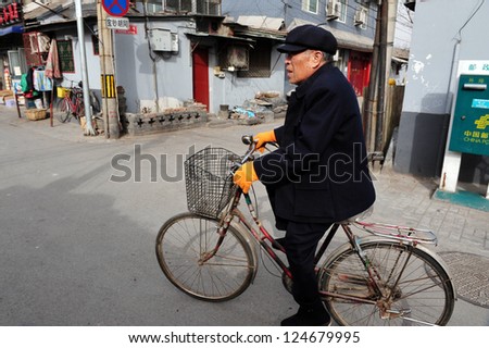 BEIJING - MARCH 12:Chinese man rides a bike on March 12 2009 in Beijing,China.Bicycle is the primary transportation for millions of Chinese.