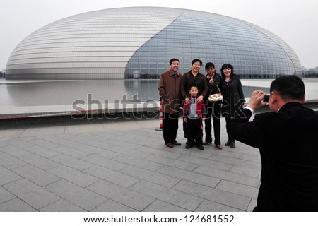 BEIJING-MERCH 15:Visitors at the National Center for the Performing Arts on Mar 15 2009 in Beijing,China.It\'s made of titanium and glass surrounded by artificial lake and seats 5,452 people in 3 halls