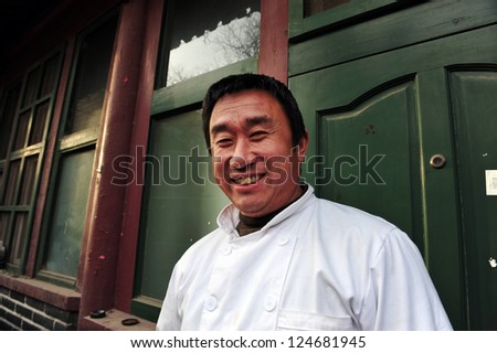 BEIJING - MARCH 11:Happy Chinese man live in a Hutong (old neighbourhood) on March 11 2009 in Beijing, China.There is around 4,000 Hutongs in Beijing some are hundreds of years old