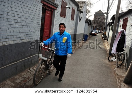 BEIJING - MARCH 13:Chinese man walk beside his bike on March 13 2009 in Beijing,China.Bicycle is the primary transportation for millions of Chinese.