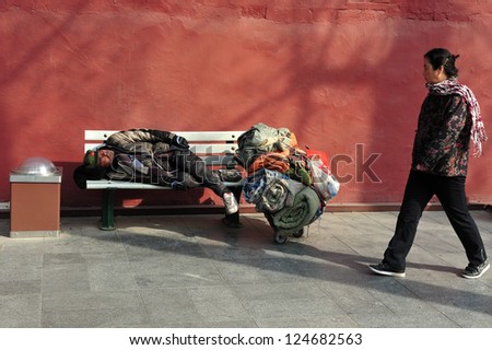 BEIJING - MARCH 11:Chinese homeless sleeeping outside The Forbidden City walls on March 11 2009 in Beijing,China.More than 135 million people in China live on less than $1 a day