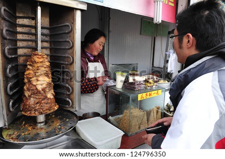 BEIJING - MARCH 15:Chinese meat in a fast food stand on March 15 2009 in Beijing, China.Millions of Chinese people eat street food every day.