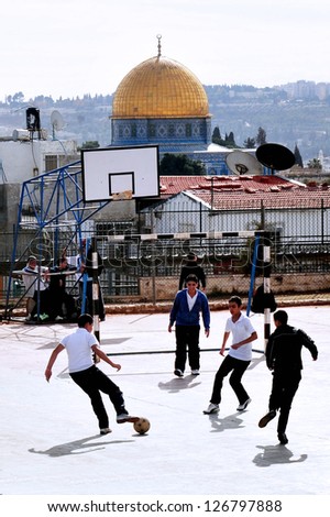 JERUSALEM - NOV 12: Arab men play football against the Golden Dome Mosque on November 08 2008 in Jerusalem, Israel.It's the most disputed holy ground between Muslims and Jewish people.