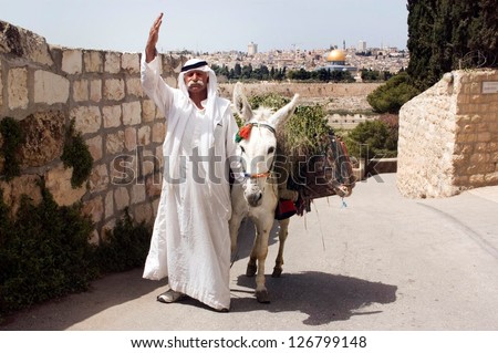 JERUSALEM - APRIL 13:Arab man and white donkey wave to peace against the Temple Mount on April 04 2006 in Jerusalem, Israel.It\'s the most disputed holy ground between Muslims and Jewish people.