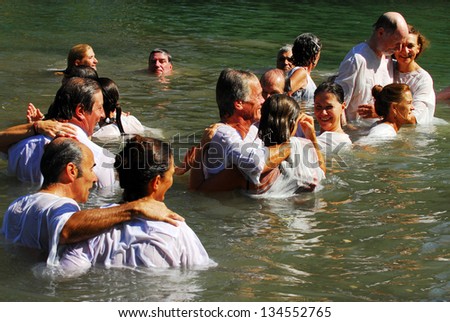 TIBERIAS - MAY 18:Christian pilgrims during mass baptism ceremony at the Jordan River in North Israel on May 18 2009.In Christian tradition, Jesus was baptised in the River Jordan by John the Baptist.