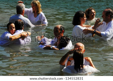 TIBERIAS - MAY 18:Christian pilgrims during mass baptism ceremony at the Jordan River in North Israel on May 18 2009.In Christian tradition, Jesus was baptised in the River Jordan by John the Baptist.