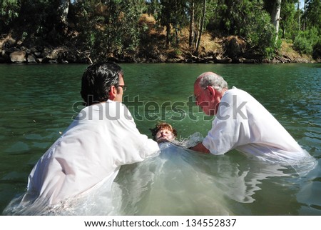 Tiberias - May 18:Christian Pilgrims During Mass Baptism Ceremony At The Jordan River In North Israel On May 18 2009.In Christian Tradition, Jesus Was Baptised In The River Jordan By John The Baptist.